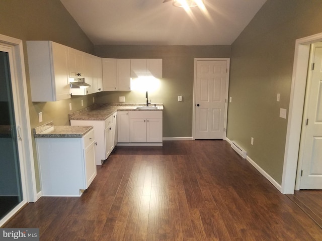 kitchen featuring dark hardwood / wood-style floors, lofted ceiling, sink, white cabinets, and baseboard heating