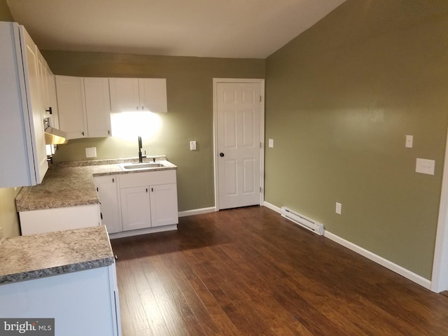 kitchen with a baseboard radiator, sink, white cabinets, and dark hardwood / wood-style floors