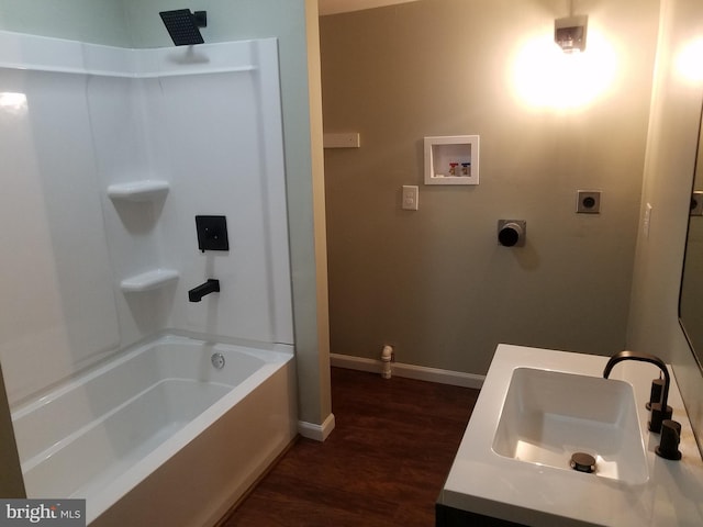 bathroom with hardwood / wood-style flooring, vanity, and shower / bathing tub combination