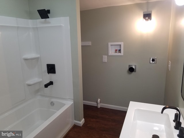 bathroom with tub / shower combination, sink, and hardwood / wood-style floors