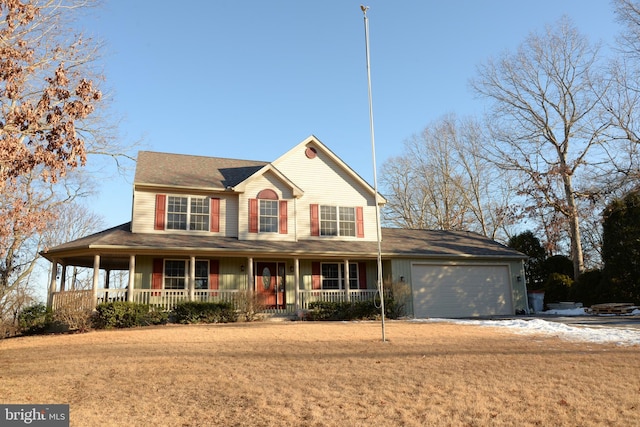 view of front of home featuring a garage, a front yard, and covered porch