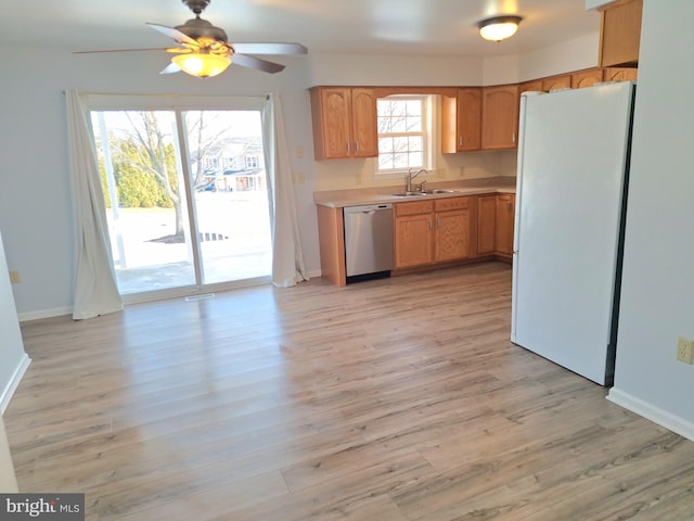 kitchen with sink, ceiling fan, dishwasher, white refrigerator, and light hardwood / wood-style floors