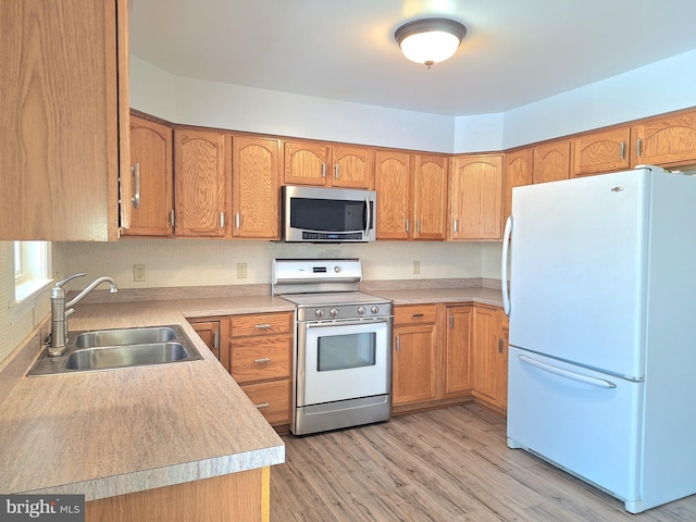 kitchen featuring sink, electric range, light hardwood / wood-style floors, and white refrigerator