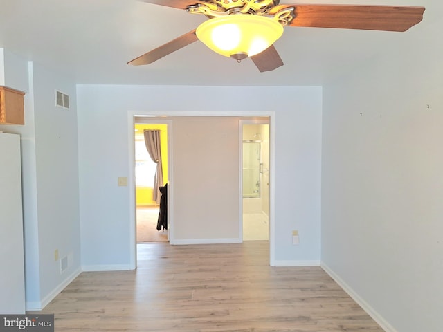 empty room featuring ceiling fan and light hardwood / wood-style floors