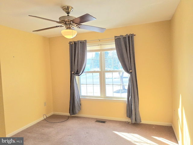 unfurnished room featuring ceiling fan and light carpet