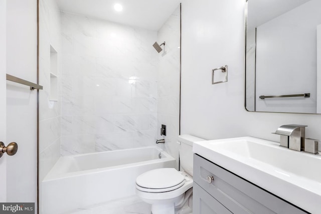 full bathroom with vanity, toilet, and tiled shower / bath