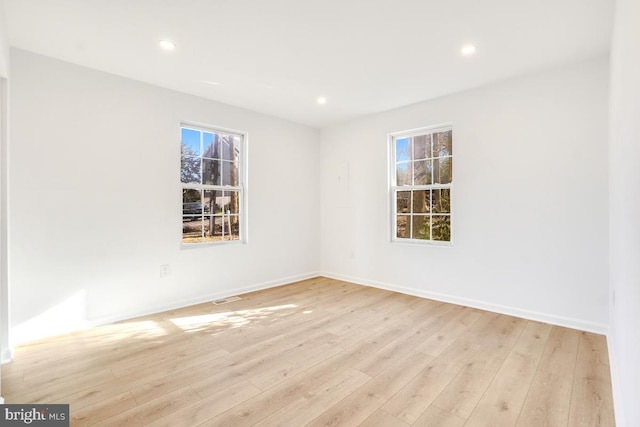 empty room with light hardwood / wood-style flooring