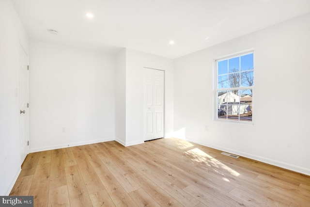 empty room with light hardwood / wood-style floors