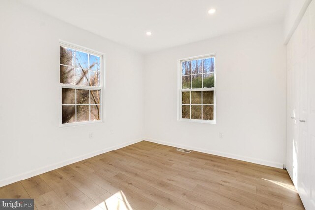 unfurnished room featuring light hardwood / wood-style floors