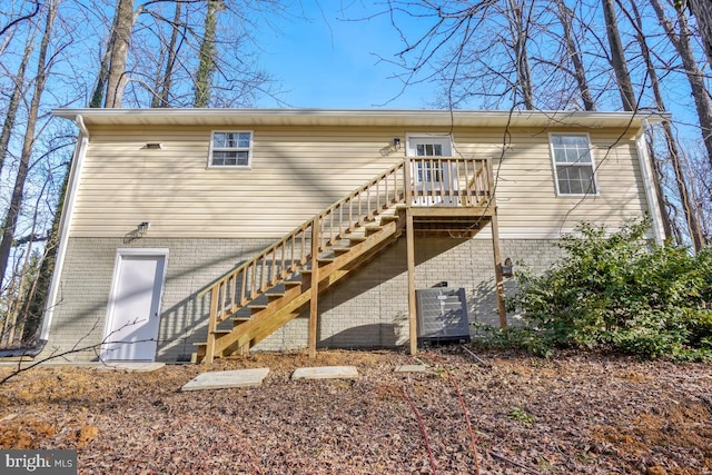 rear view of property featuring a wooden deck