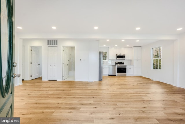 unfurnished living room with light wood-type flooring