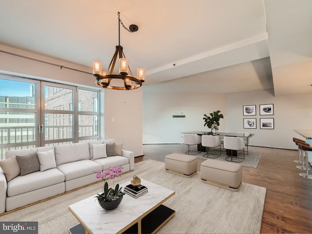 living room with an inviting chandelier and hardwood / wood-style floors