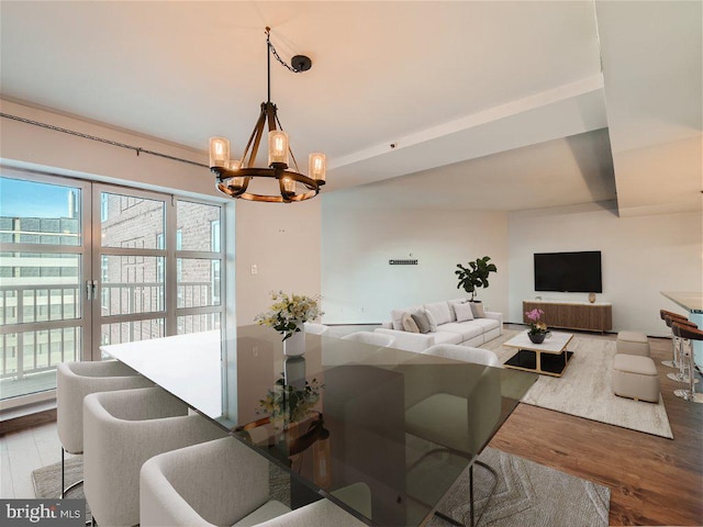 dining area featuring hardwood / wood-style floors and a notable chandelier