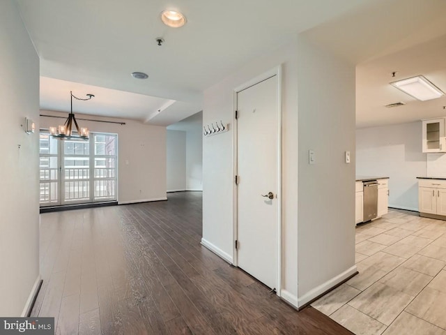 interior space with a notable chandelier and light wood-type flooring