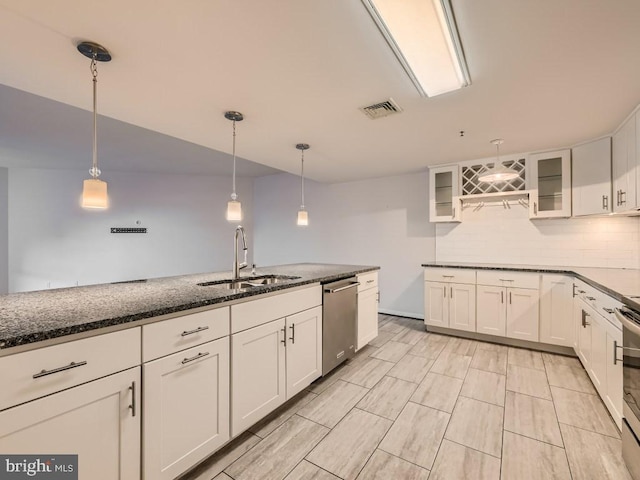 kitchen with white cabinetry, appliances with stainless steel finishes, sink, and hanging light fixtures