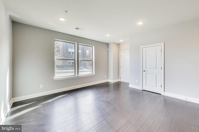 unfurnished room featuring dark wood-type flooring