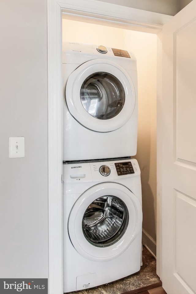 washroom featuring stacked washer and dryer