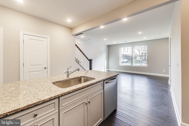 kitchen featuring dishwasher, light stone countertops, sink, and dark hardwood / wood-style floors