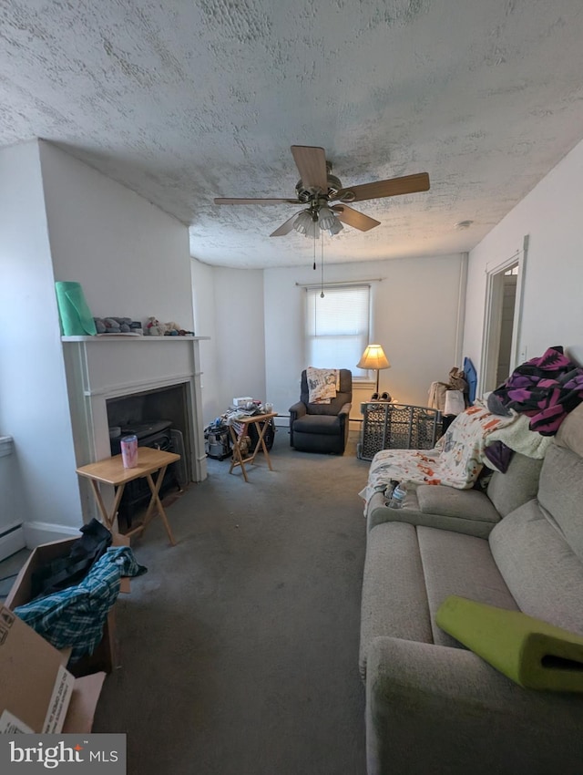 carpeted living room featuring ceiling fan and a textured ceiling