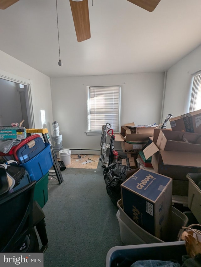 interior space featuring a baseboard heating unit and carpet flooring