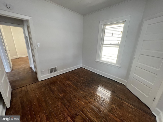 unfurnished room featuring dark wood-type flooring