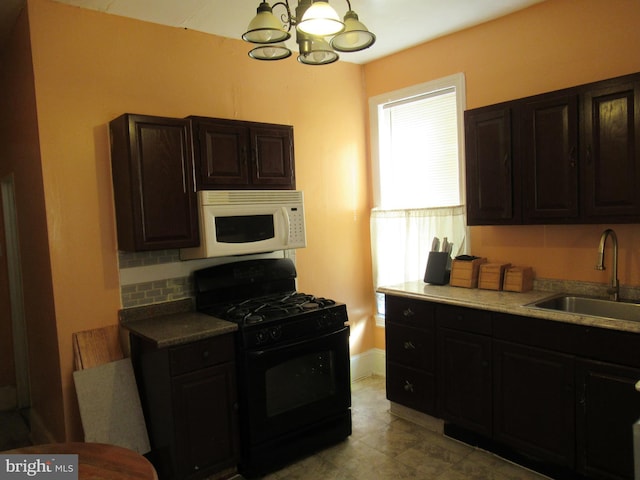 kitchen featuring sink, black gas range, dark brown cabinets, tasteful backsplash, and a chandelier