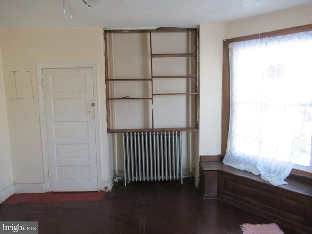 interior space with radiator and dark wood-type flooring