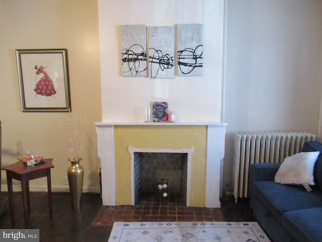 living room featuring radiator and a tile fireplace