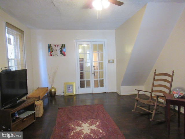 living room featuring dark hardwood / wood-style floors, ceiling fan, and french doors