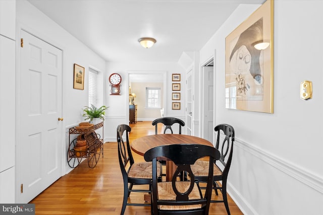 dining space with light hardwood / wood-style flooring