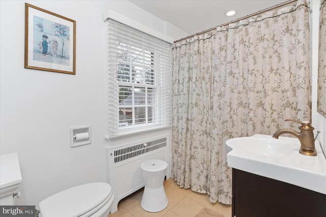 bathroom featuring radiator heating unit, curtained shower, vanity, toilet, and tile patterned floors