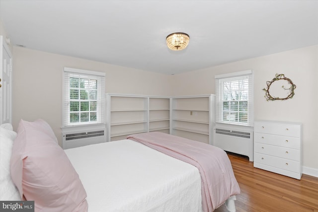 bedroom featuring radiator and light wood-type flooring