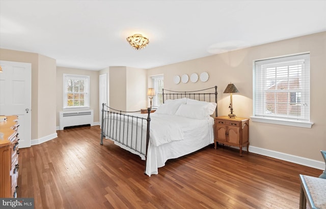 bedroom featuring radiator and dark hardwood / wood-style flooring