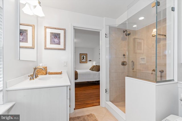 bathroom featuring vanity, tile patterned flooring, and a tile shower