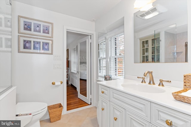 bathroom featuring tile patterned floors, vanity, and toilet