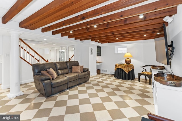 living room with beamed ceiling and ornate columns