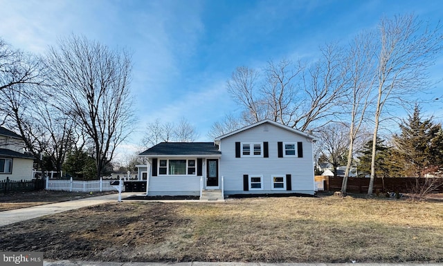 split level home featuring a front lawn