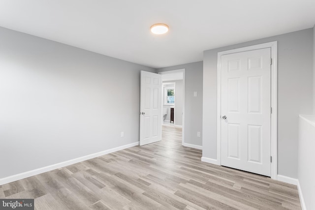 unfurnished bedroom with light wood-type flooring