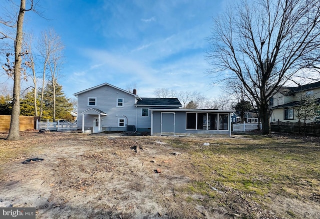 rear view of property with a sunroom and central air condition unit