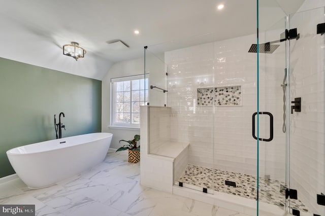 bathroom featuring lofted ceiling and shower with separate bathtub