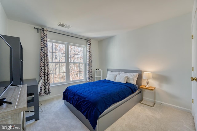 bedroom with light colored carpet