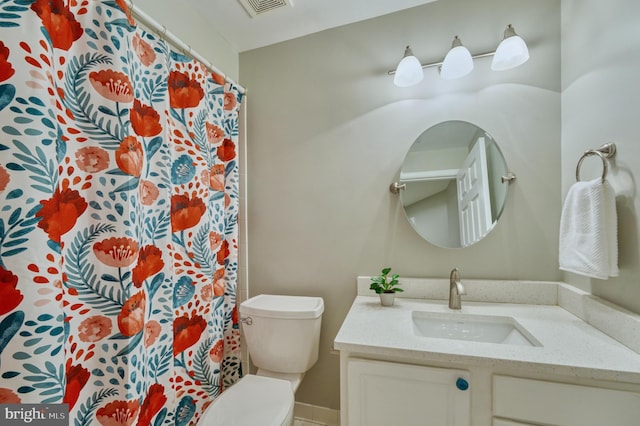 bathroom featuring vanity and toilet