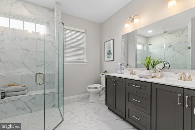 bathroom with vanity, toilet, and a shower with door