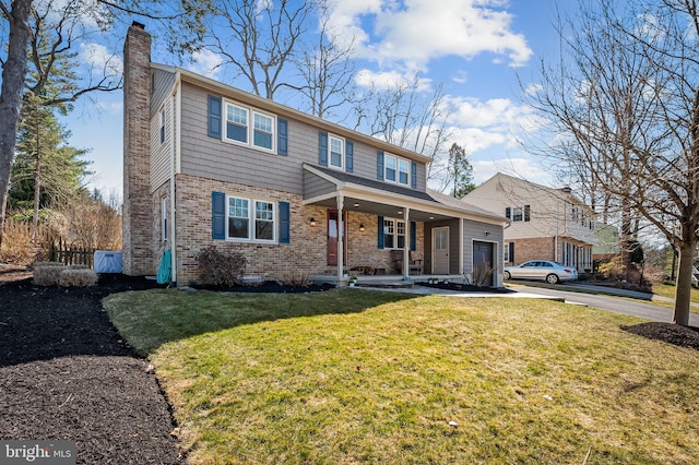 view of front of home with driveway, fence, a front yard, brick siding, and a chimney