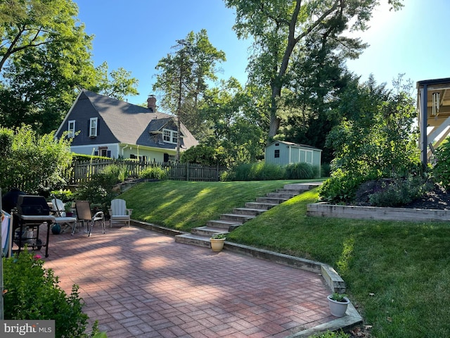 view of patio with an outdoor structure and fence