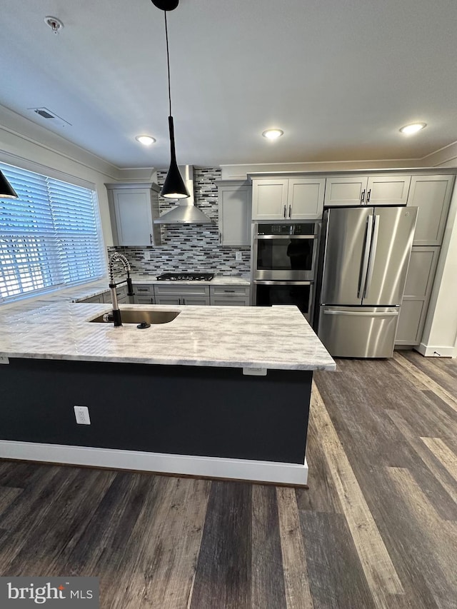 kitchen featuring dark wood-type flooring, sink, decorative light fixtures, gray cabinets, and stainless steel appliances