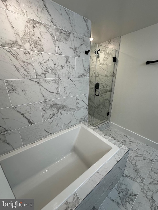 bathroom with shower with separate bathtub