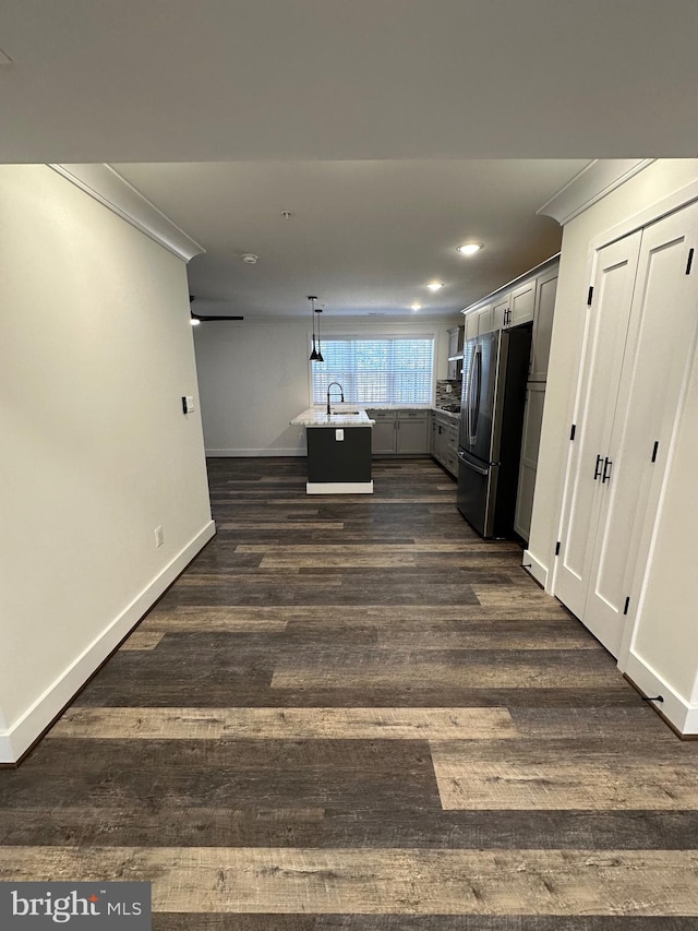 interior space featuring ornamental molding, dark hardwood / wood-style flooring, and sink