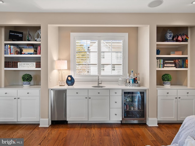 bar featuring white cabinets, fridge, sink, and wine cooler