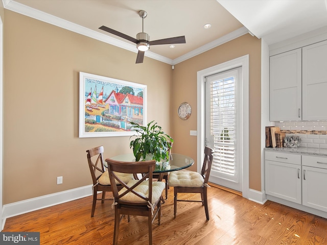 dining area with ornamental molding, ceiling fan, and light wood-type flooring